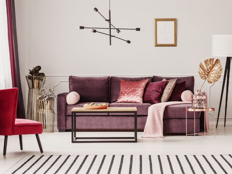 Purple is one of the colors that complements red in a luxurious living space